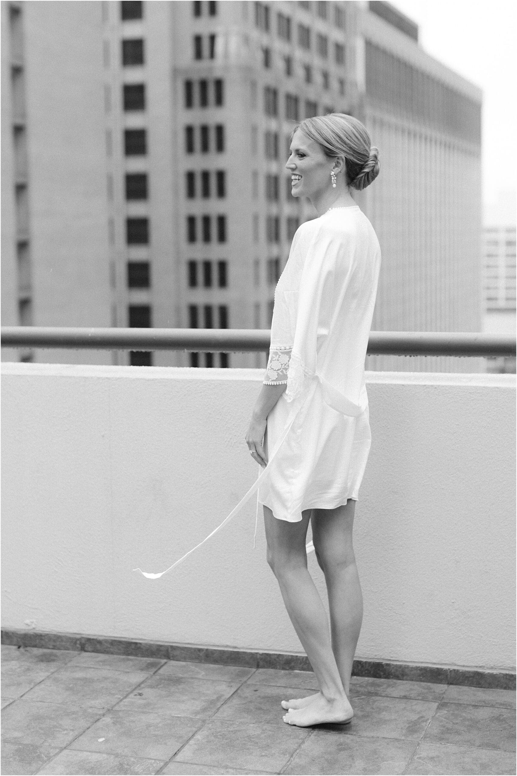 bride on a balcony at the adolphus hotel in dallas texas 