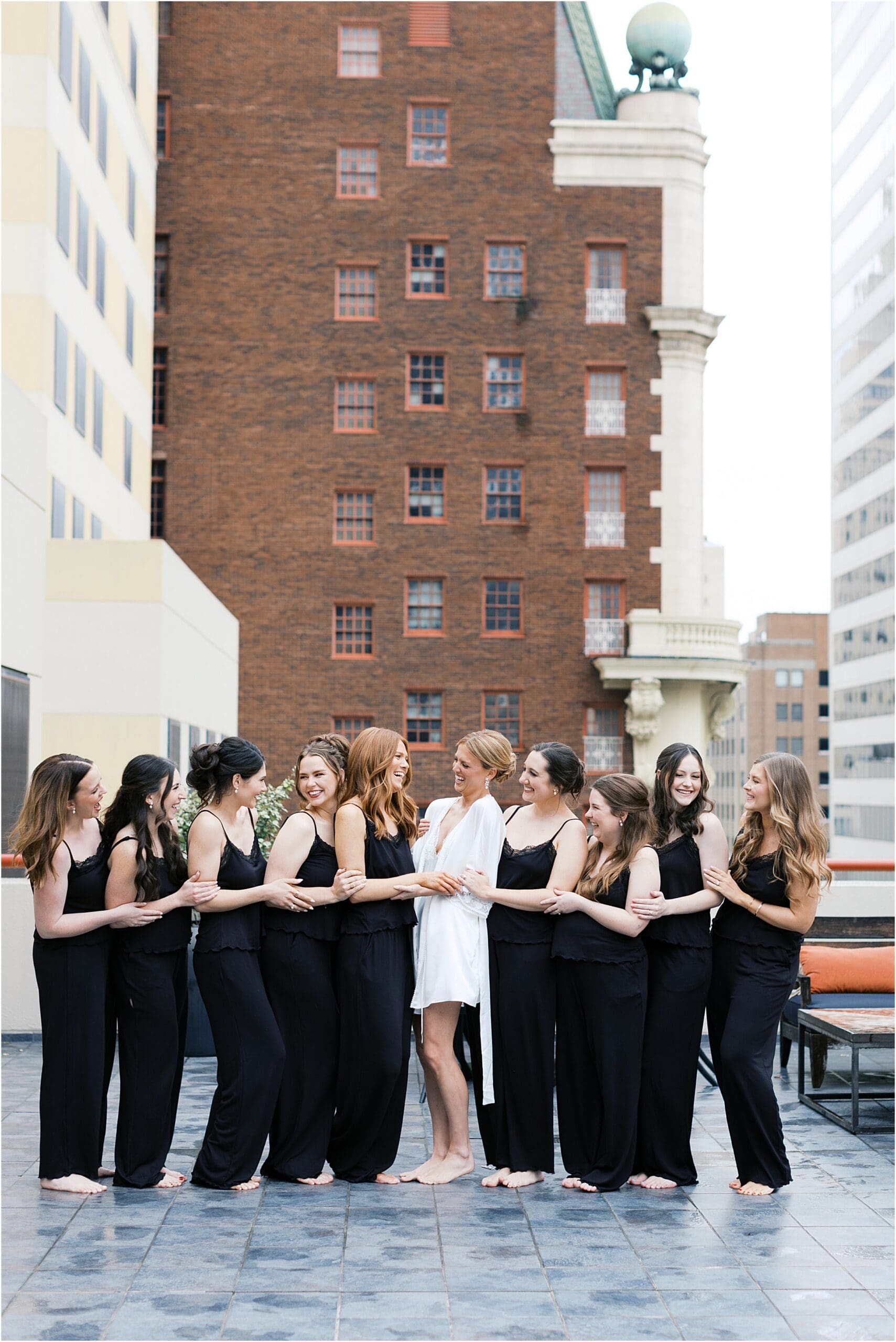 bride and bridesmaids on a balcony at the adolphus hotel in dallas texas