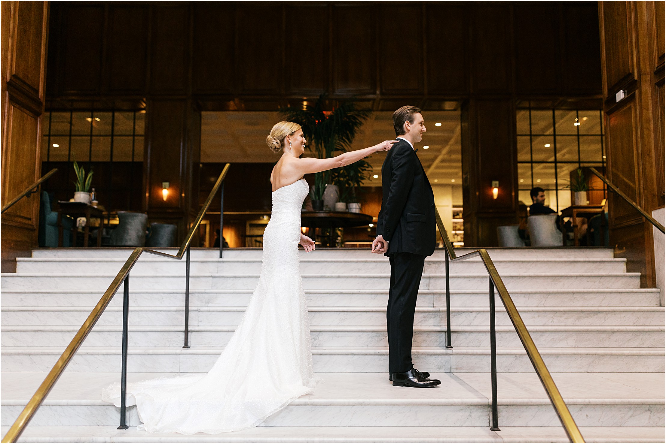bride and groom first look at adolphus hotel on marble staircase in dallas texas