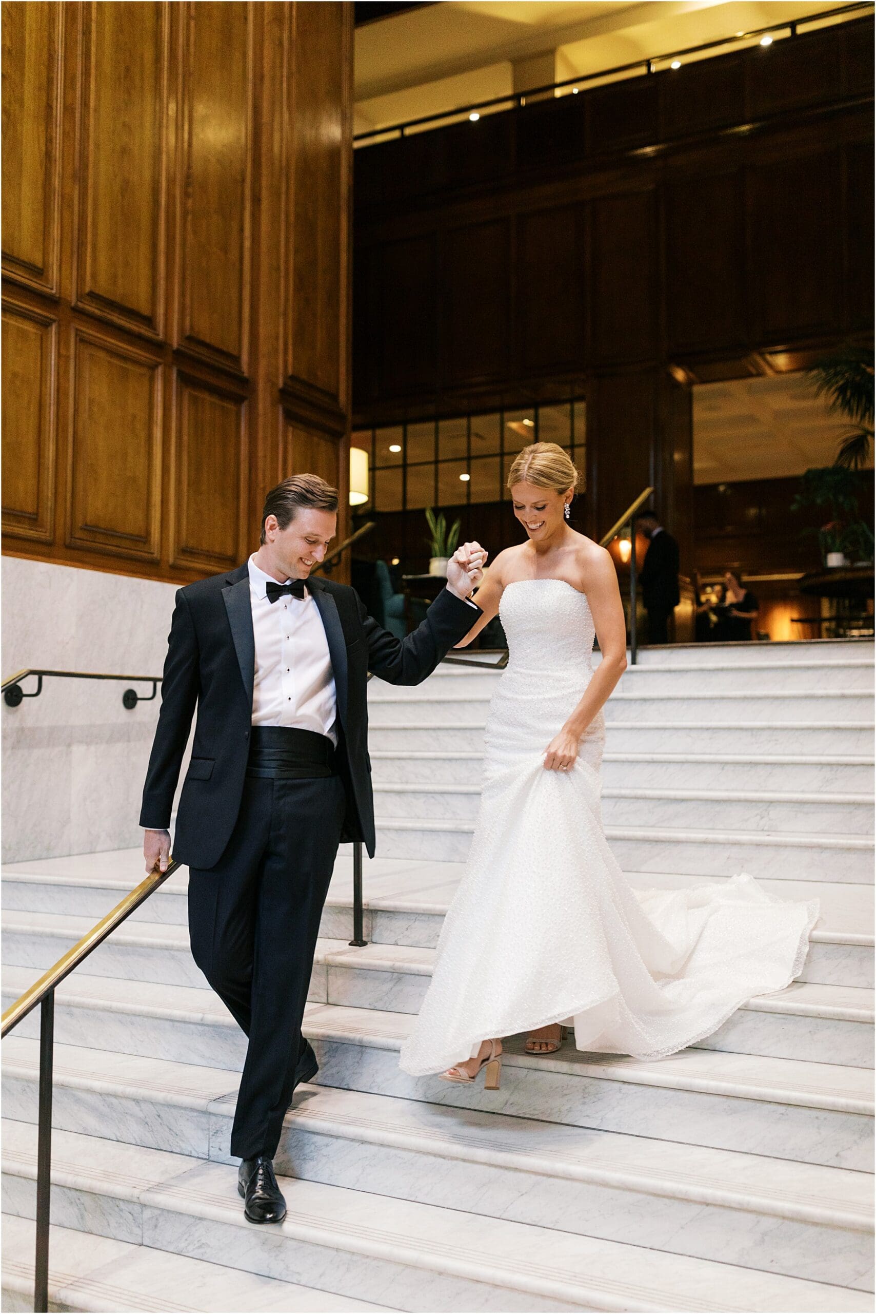 bride and groom at adolphus hotel on marble staircase in dallas texas