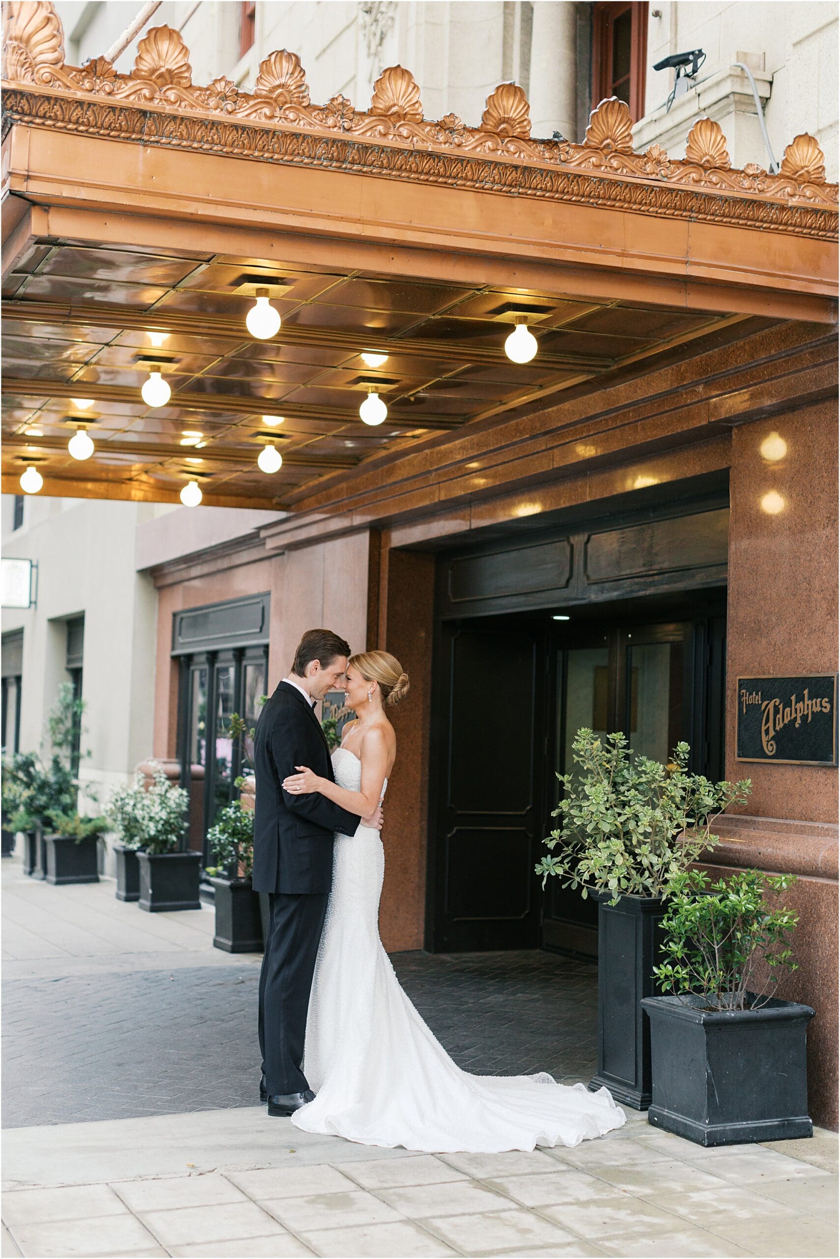 bride and groom in front of adolphus hotel in dallas texas