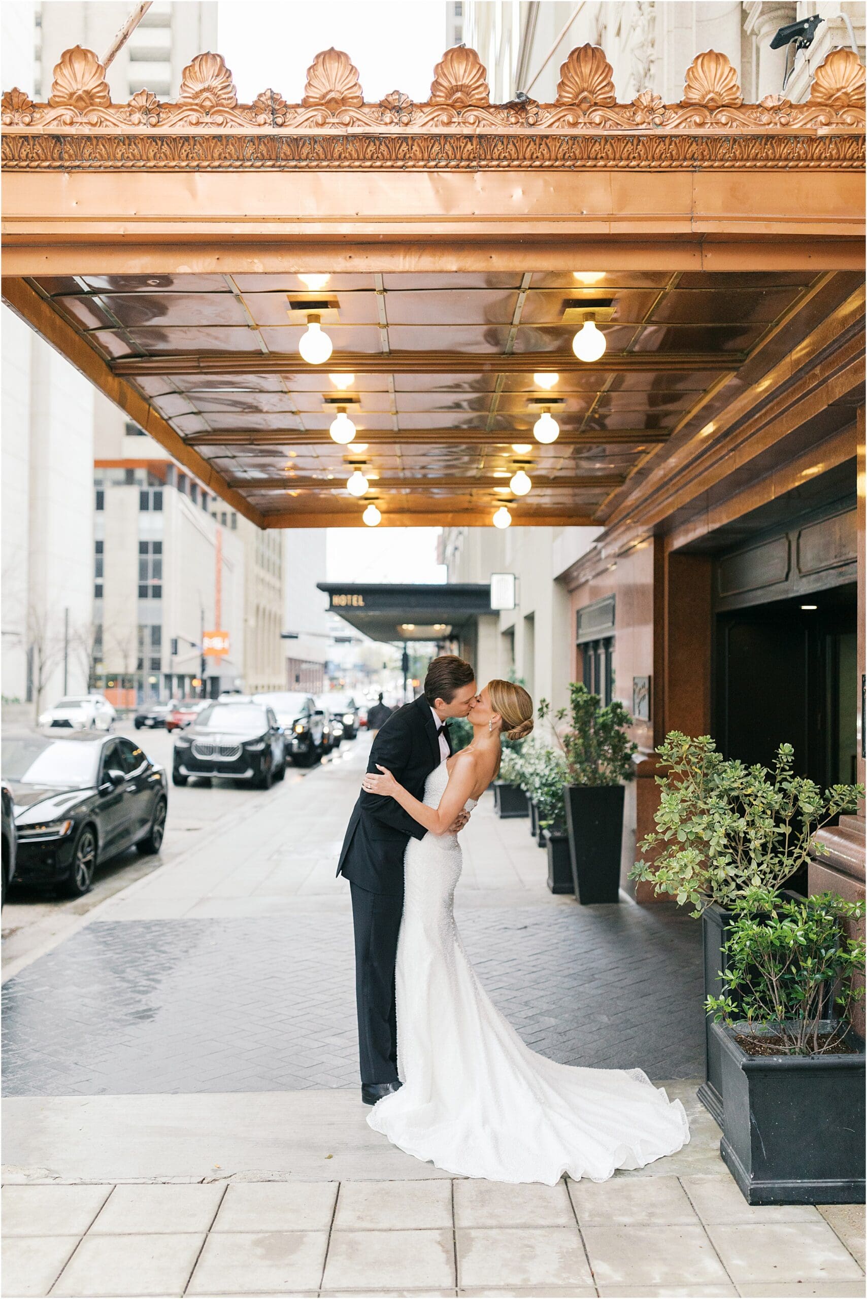bride and groom in front of adolphus hotel in dallas texas