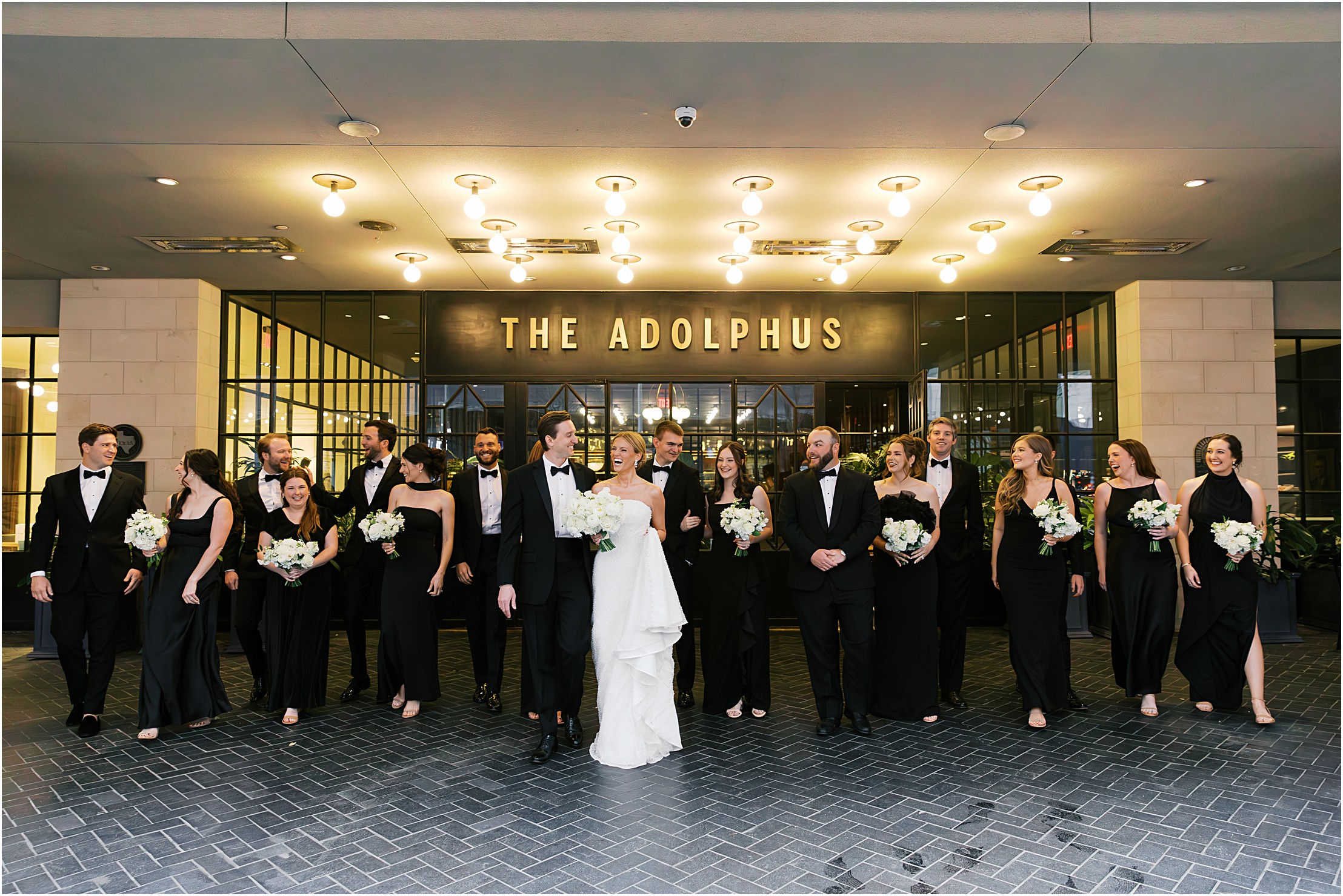 wedding party walking in front of the adolphus hotel in dallas texas