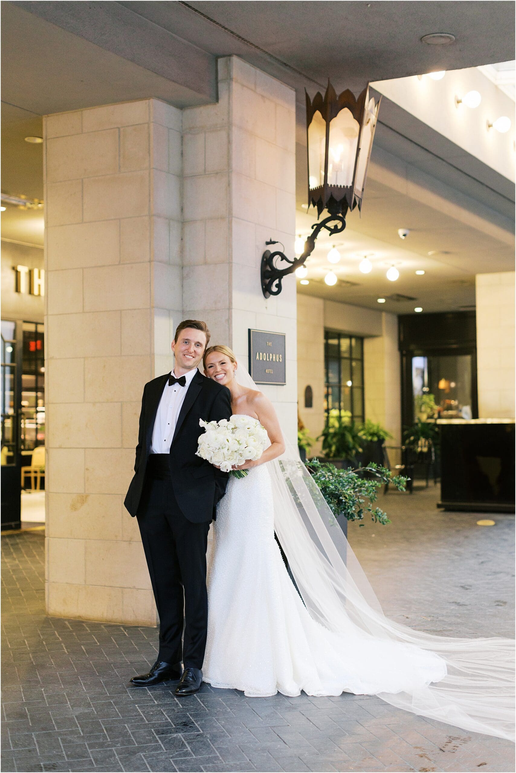 bride and groom in front of adolphus hotel in dallas texas