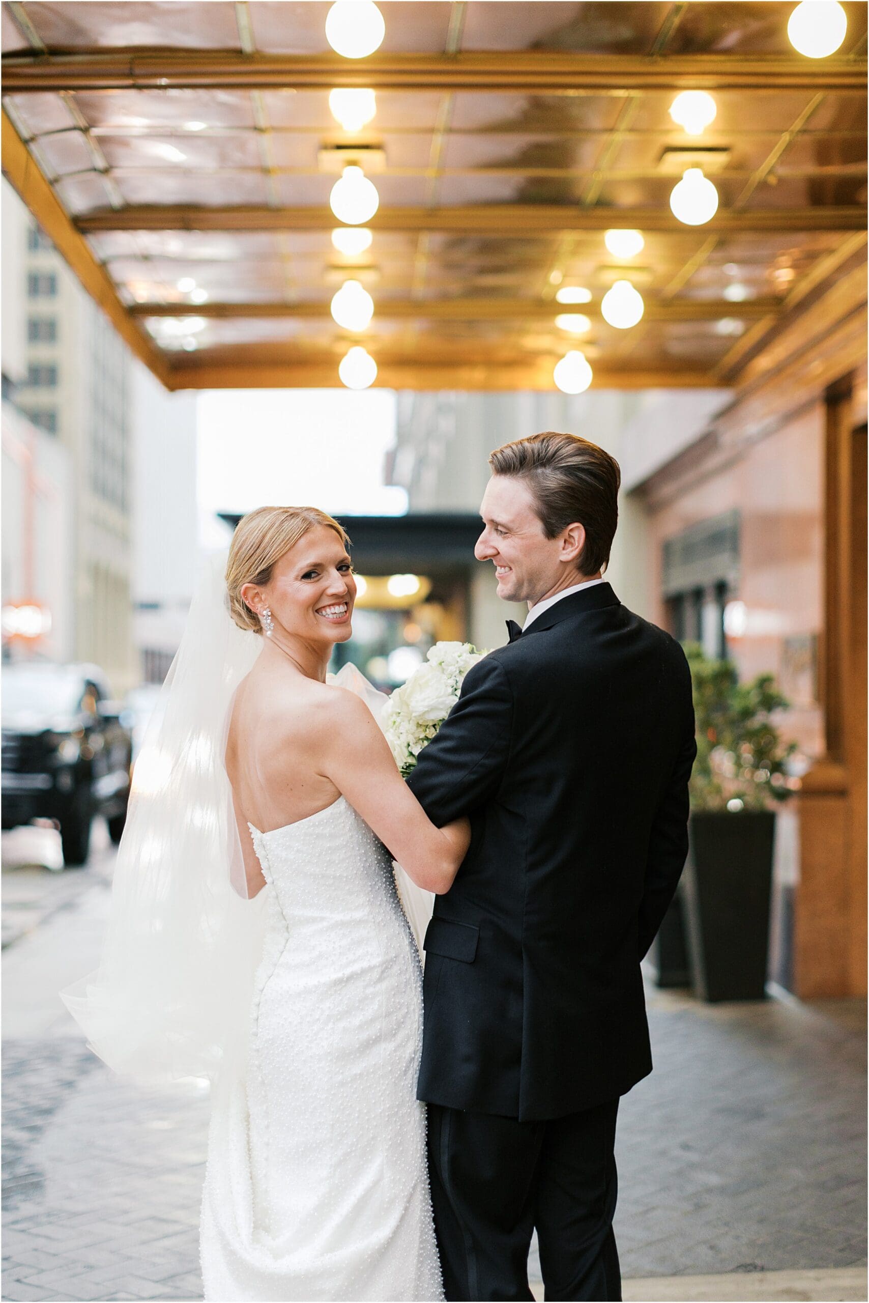 bride and groom in front of adolphus hotel in dallas texas