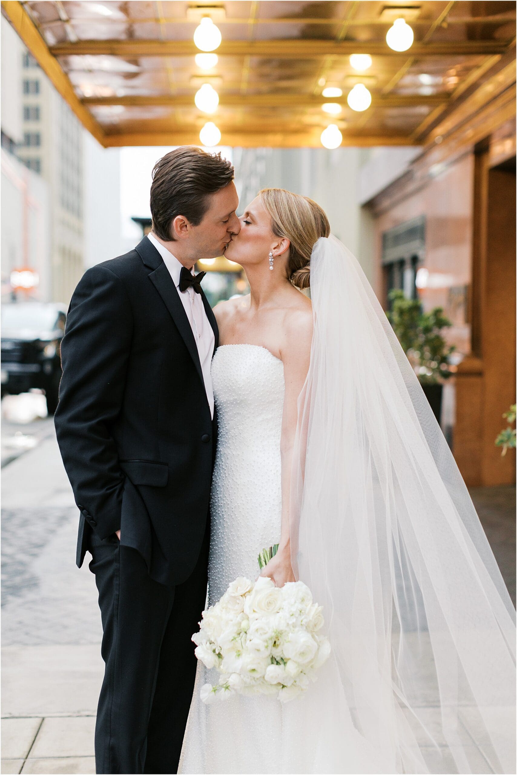 bride and groom in front of adolphus hotel in dallas texas