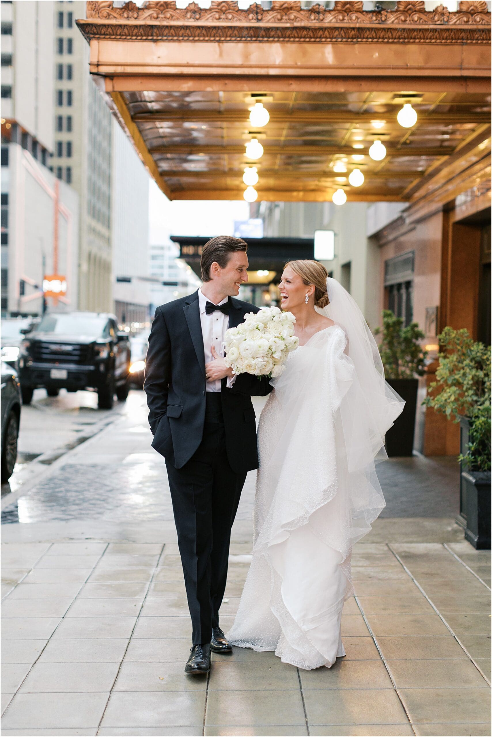 bride and groom in front of adolphus hotel in dallas texas
