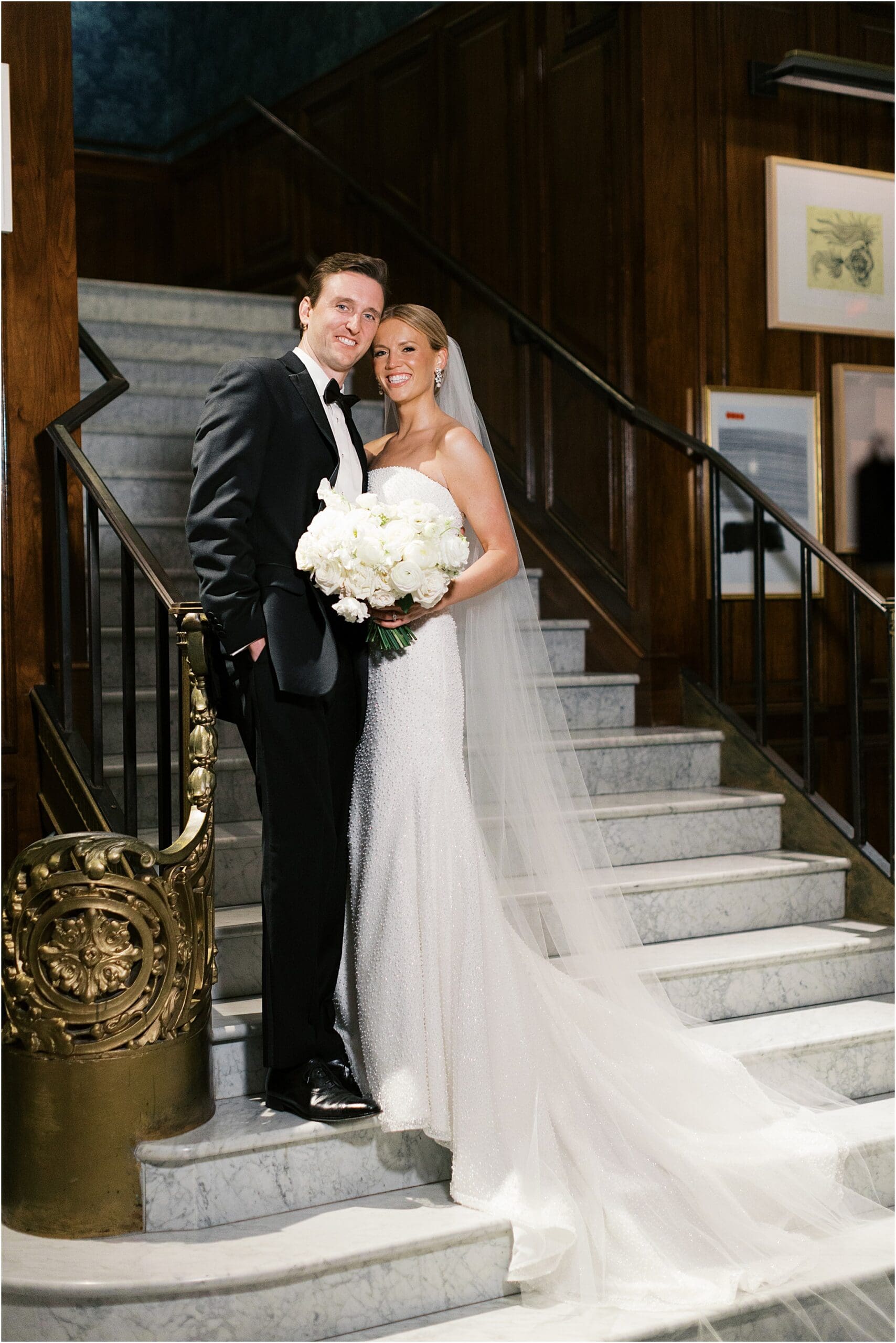 bride and groom on marble stairs in French Room lobby at Adolphus hotel in dallas texas