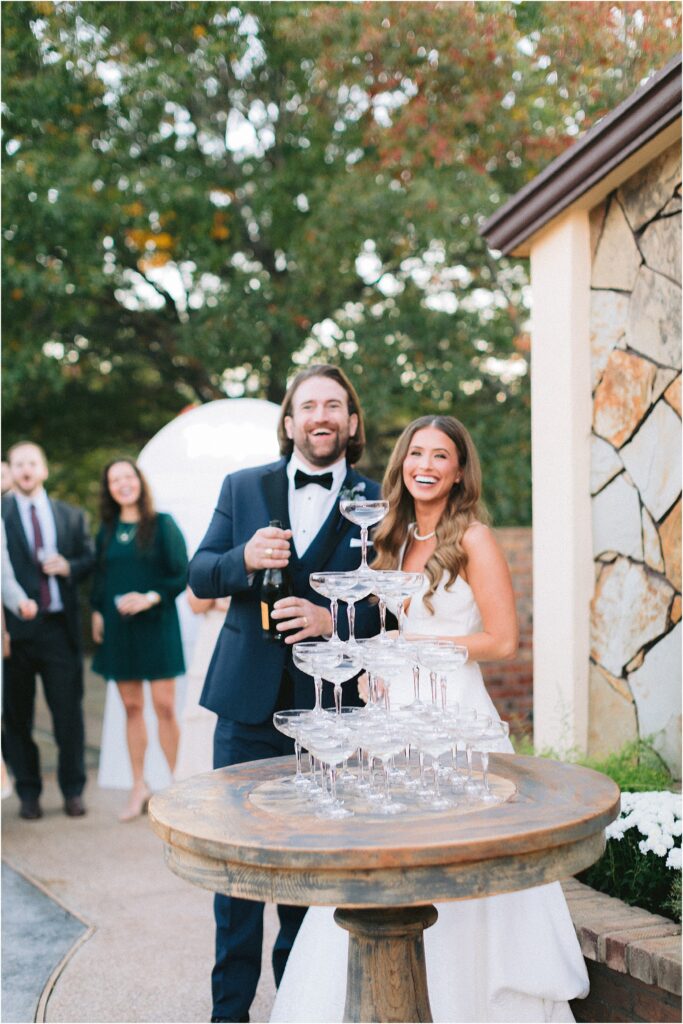 bride and groom with champagne tower at wedding reception at stoney ridge villa in fort worth texas