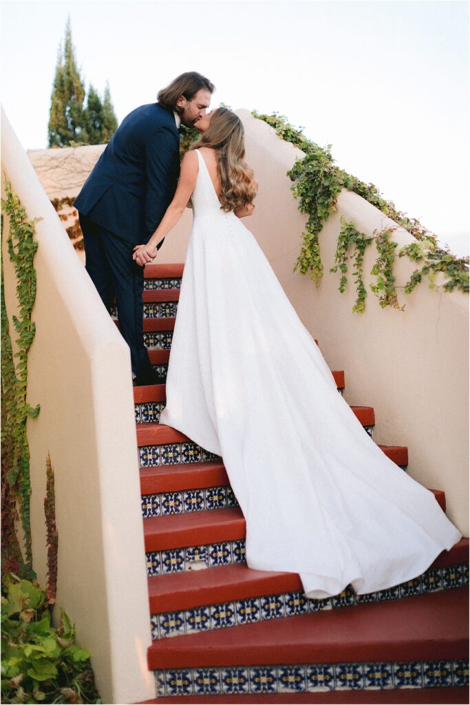 Bride and groom walking up stairs at stone ridge villa in fort worth Texas