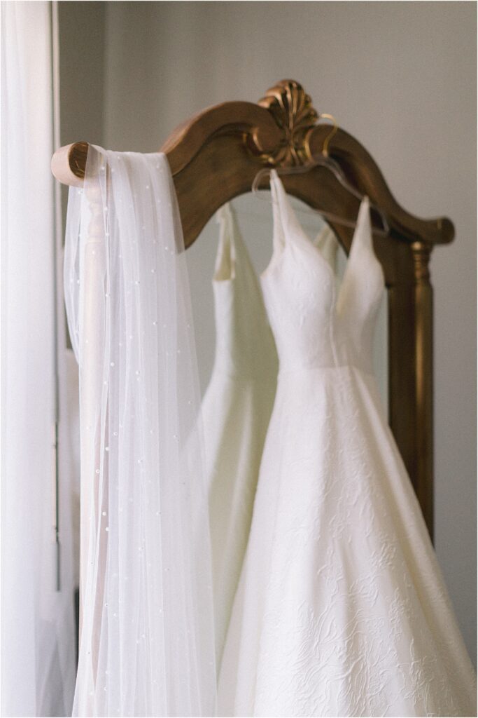 brides dress on gold mirror with pearl veil