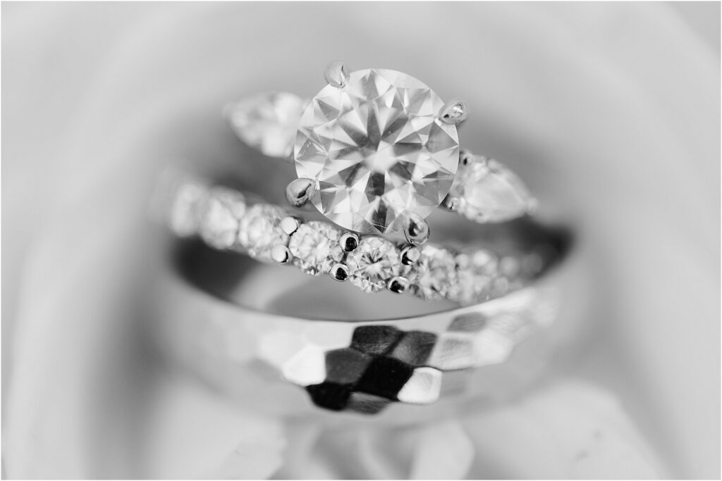 macro black and white photo of bride and groom rings