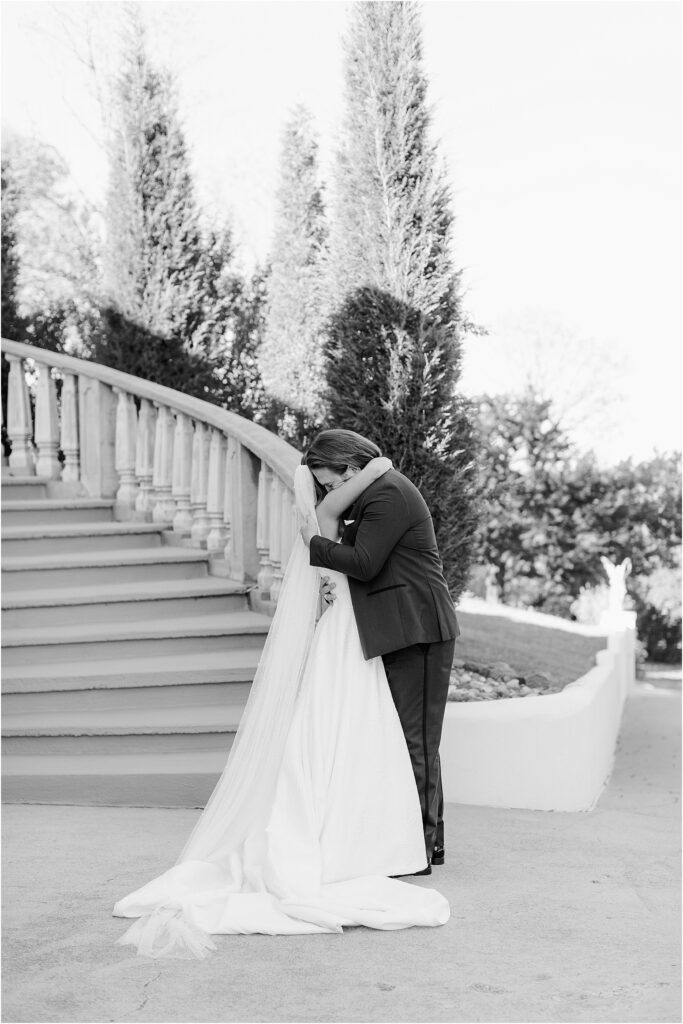 first look with a bride and groom on grand stairs at stoney ridge villa in fort worth Texas