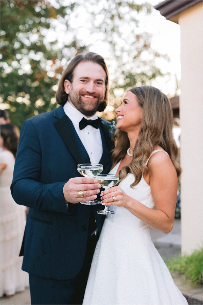 bride and groom with champagne tower at wedding reception at stoney ridge villa in fort worth texas
